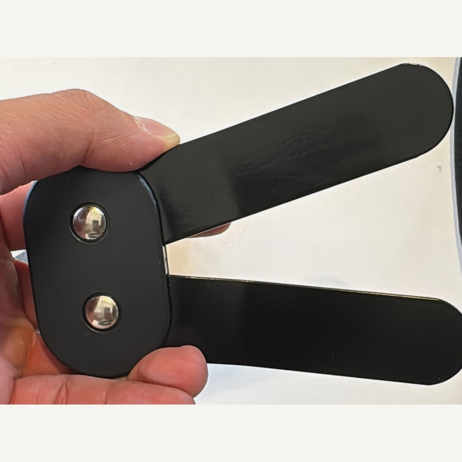 Photo 5: the hinge taken out of the brace and photographed in hand — the actual part, unretouched